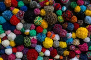 Colorful balls of yarn arranged together, representing the handcrafted aesthetic of Yoshi's Woolly World