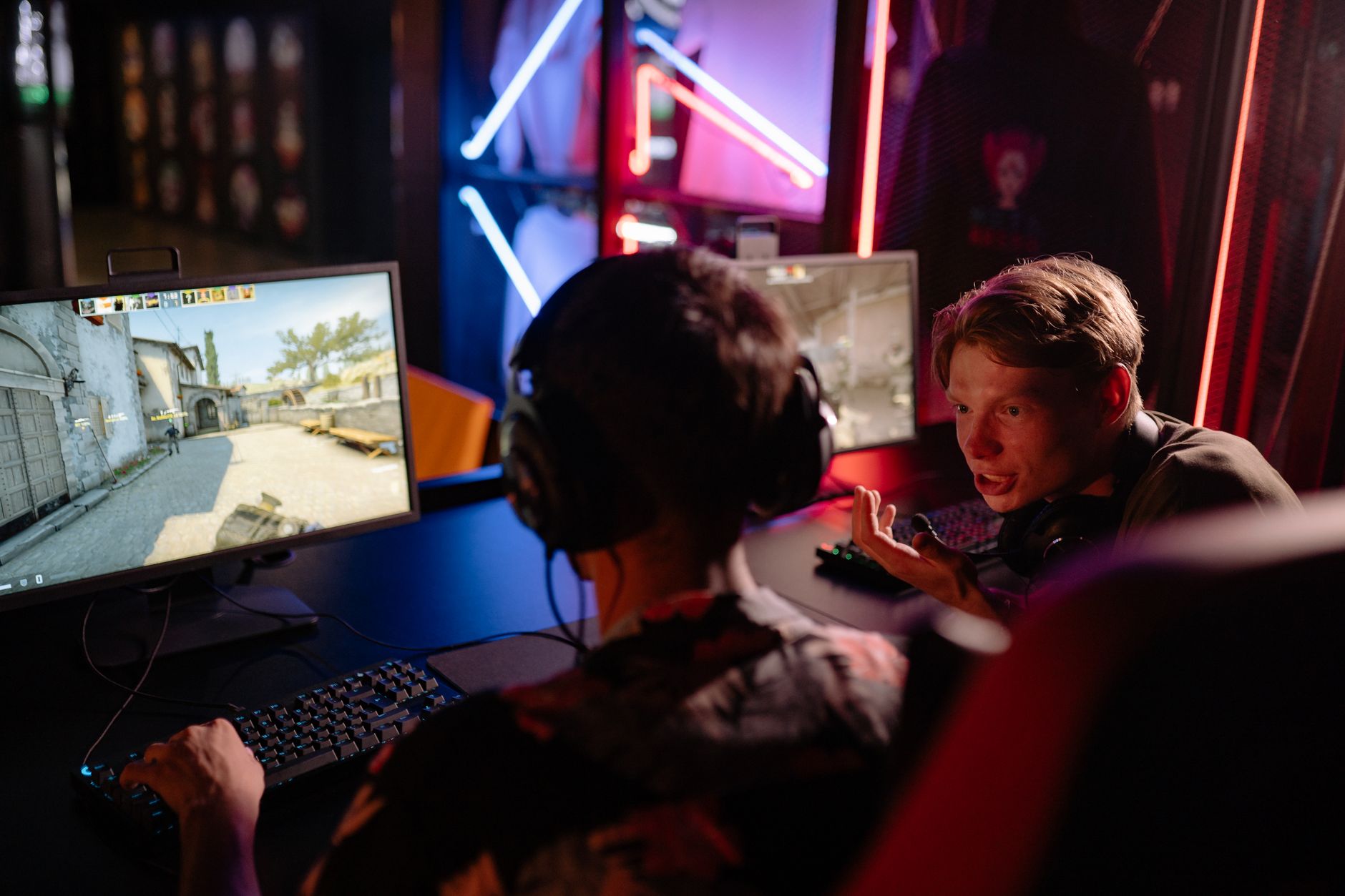 Players competing in a multiplayer video game on a large screen