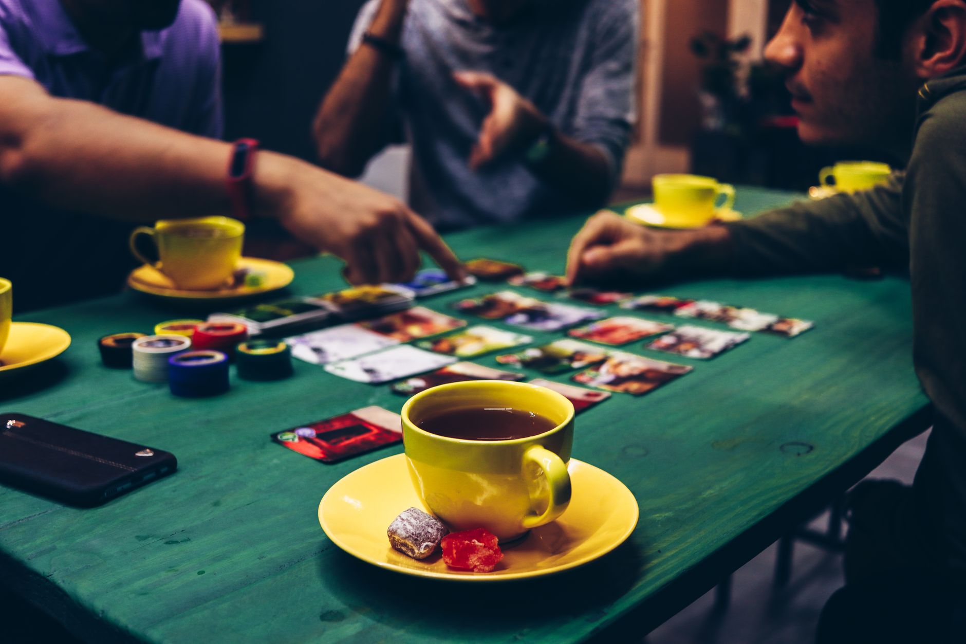 Close-up of a strategy board game with grid layout and small colored pieces