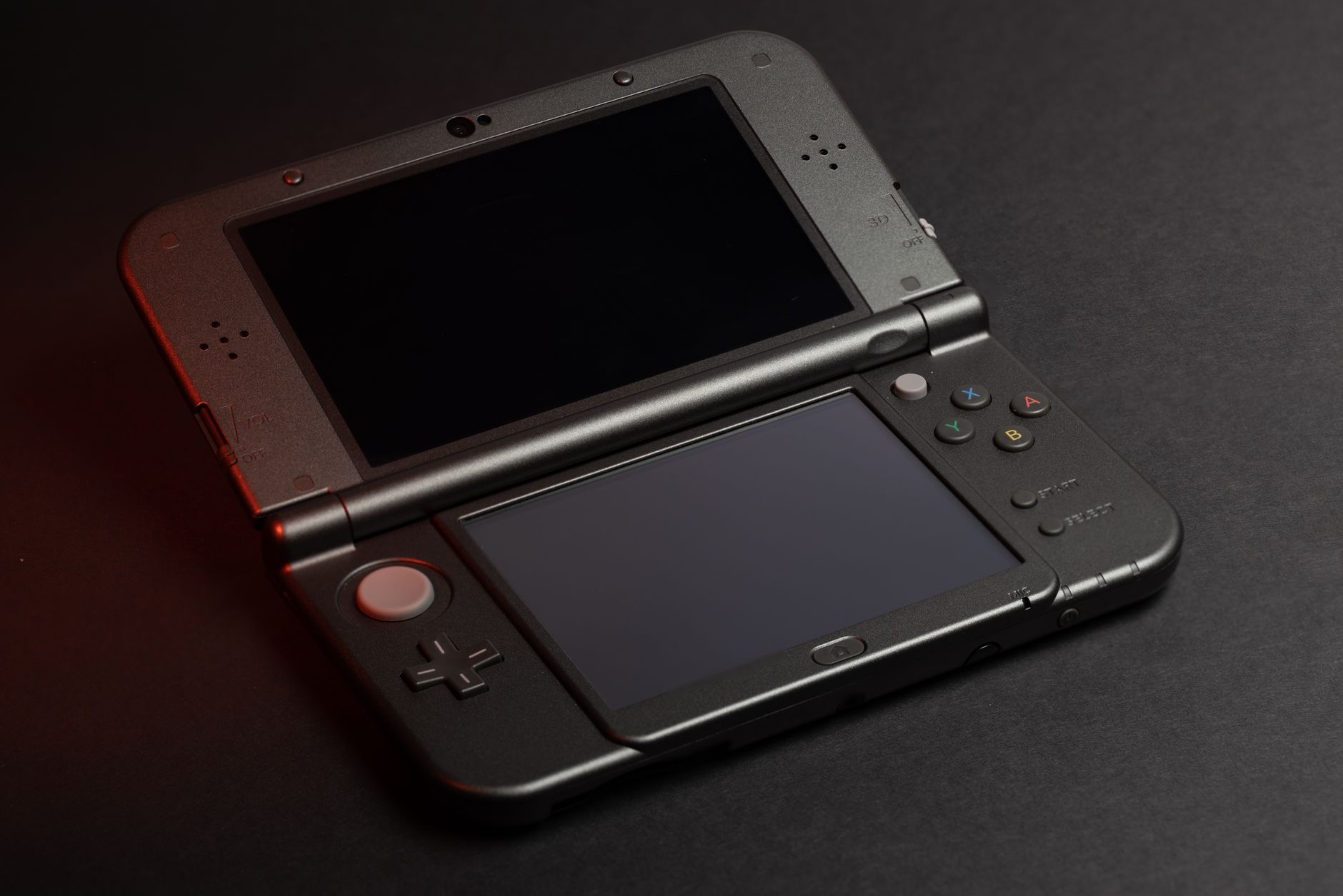 Person holding a handheld gaming console while playing a puzzle game
