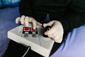 A vintage game controller resting on a surface, representing classic gaming challenge