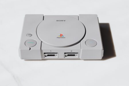 A classic retro gaming console and controller on a shelf representing vintage Nintendo hardware