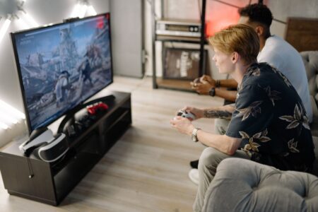 A gaming console connected to a television displaying a sci-fi game environment