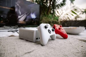 A gaming setup with a large television displaying a colorful video game