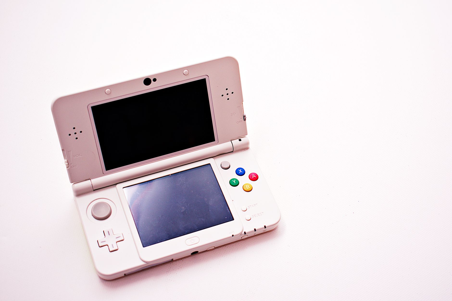 Person playing a handheld gaming console on a couch during a casual session