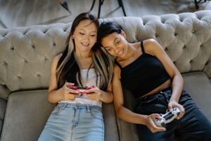Donkey Kong Bananza’s Absent Multiplayer Mode Is Quietly Isolating Couch Co-Op Fans Two people sitting on a couch playing video games together with controllers in hand