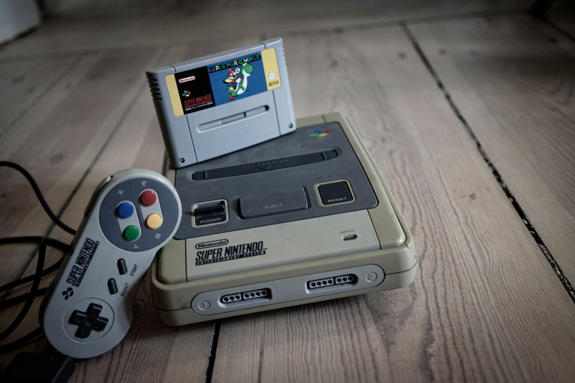 Classic retro gaming console and cartridges representing Donkey Kong Country legacy