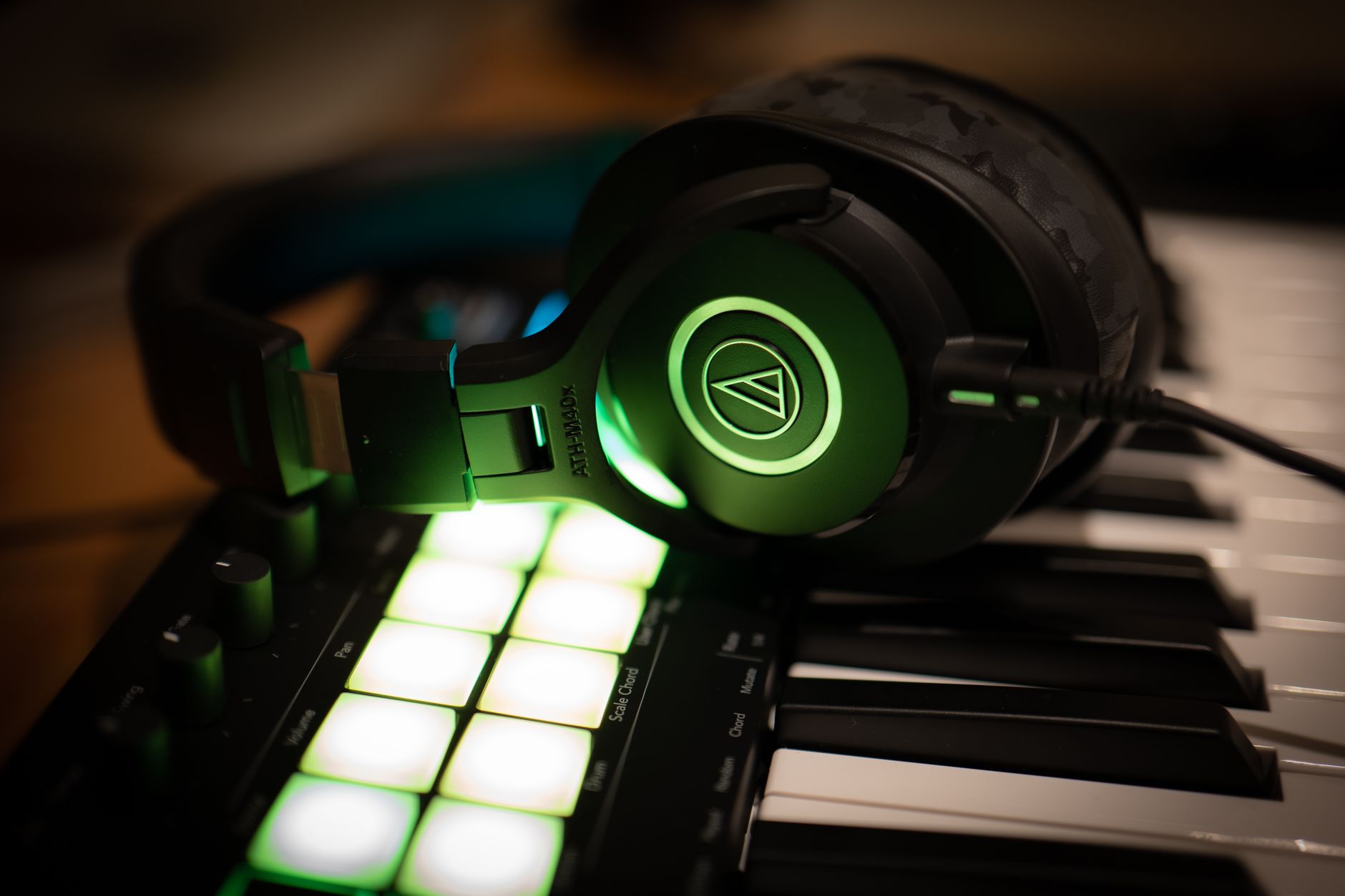 A person wearing headphones in a music production setting, representing video game soundtrack composition