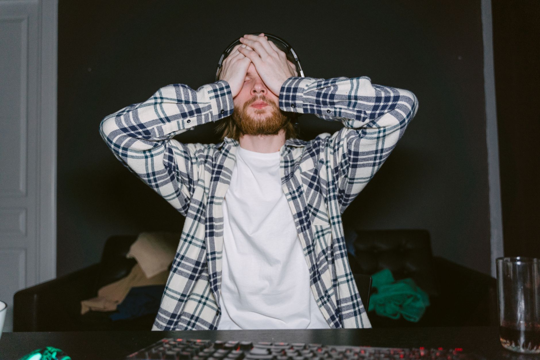 A player sitting at a screen with a look of fatigue, reflecting the exhaustion some Donkey Kong Bananza players feel in late-game segments