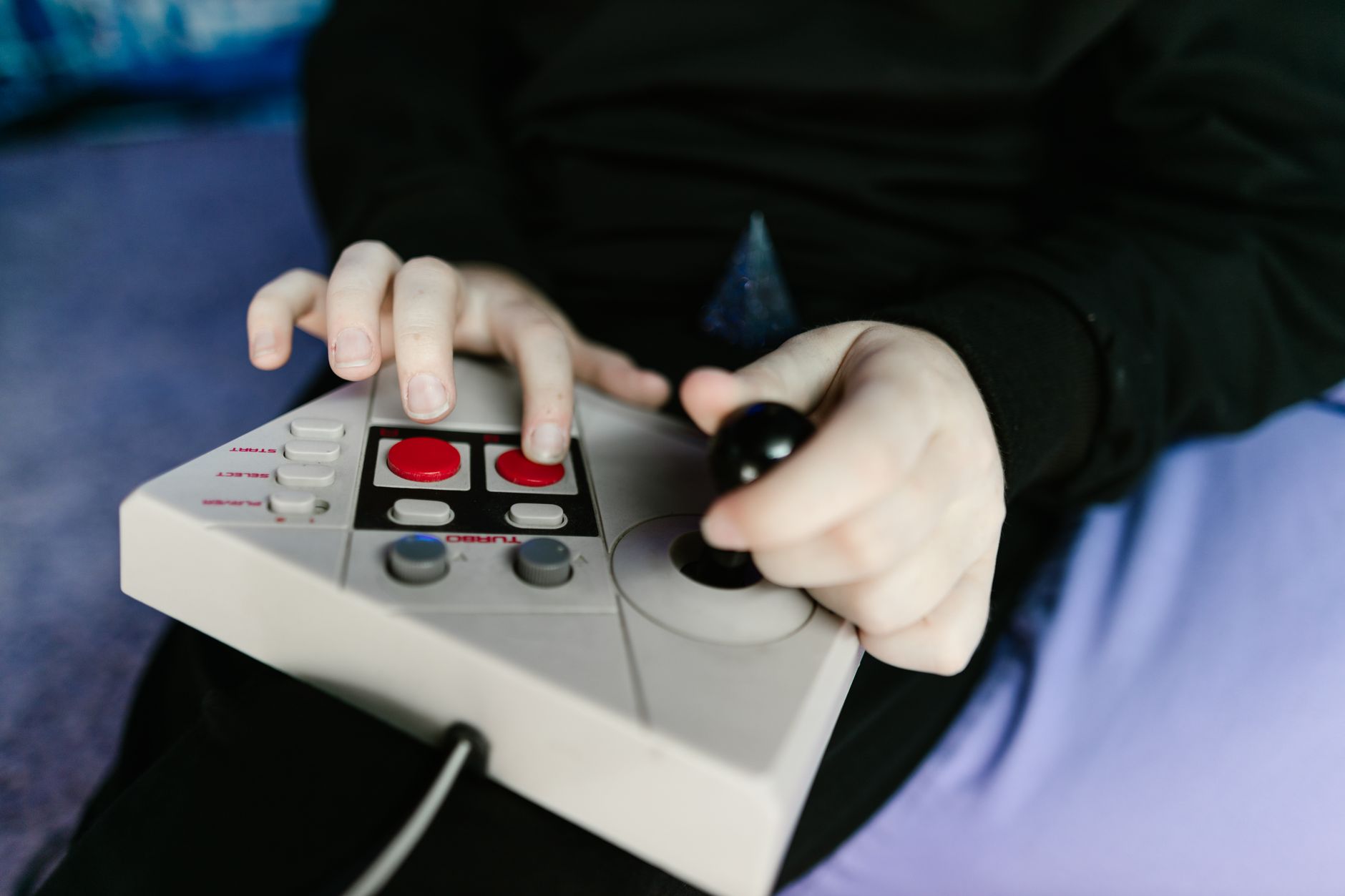 A vintage video game controller resting on a surface, representing classic gaming nostalgia