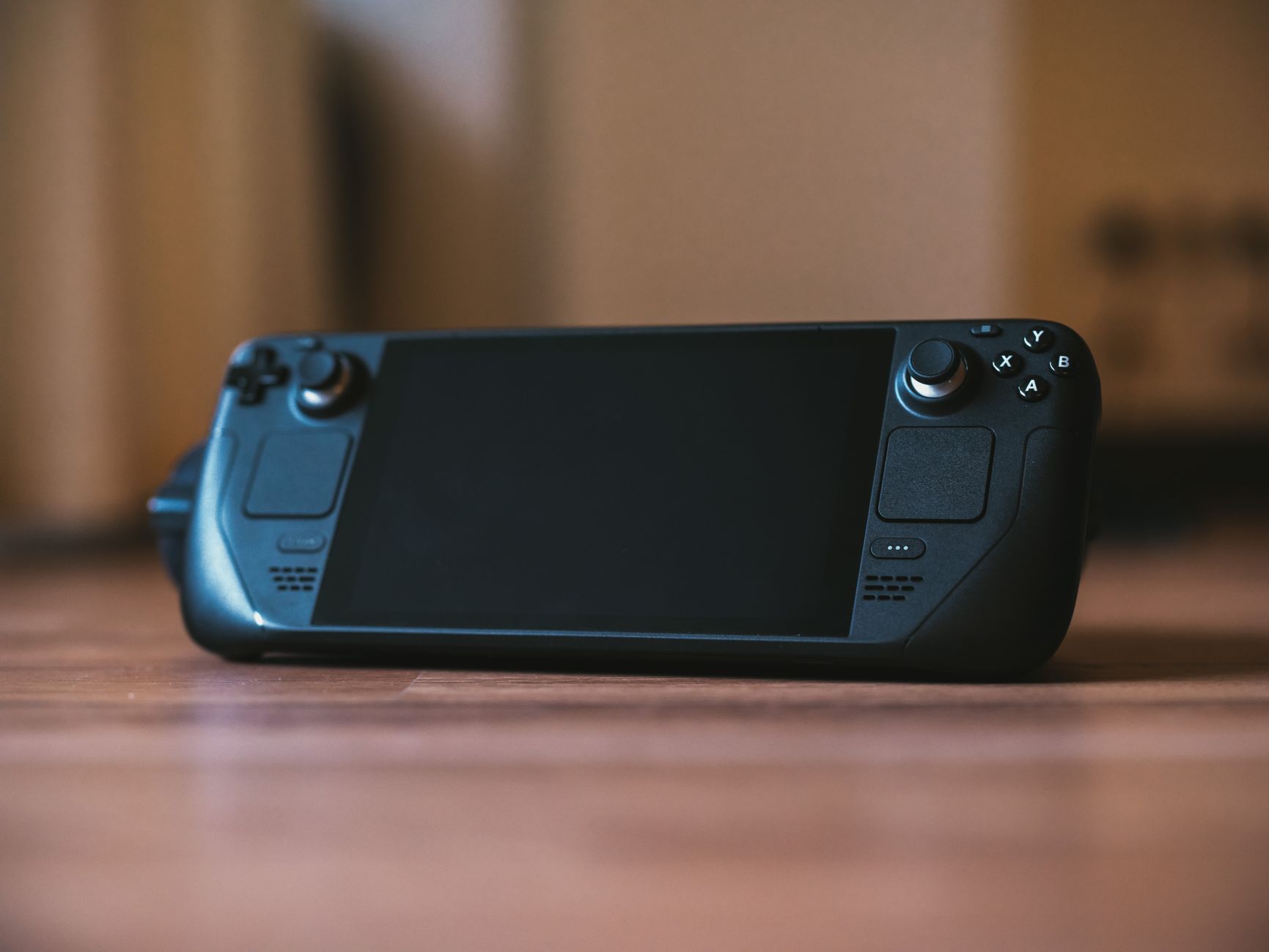 Handheld gaming device held in hands during a mobile gaming session